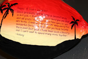 This sunset silhouette anniversary gift is painted on a whole size coconut