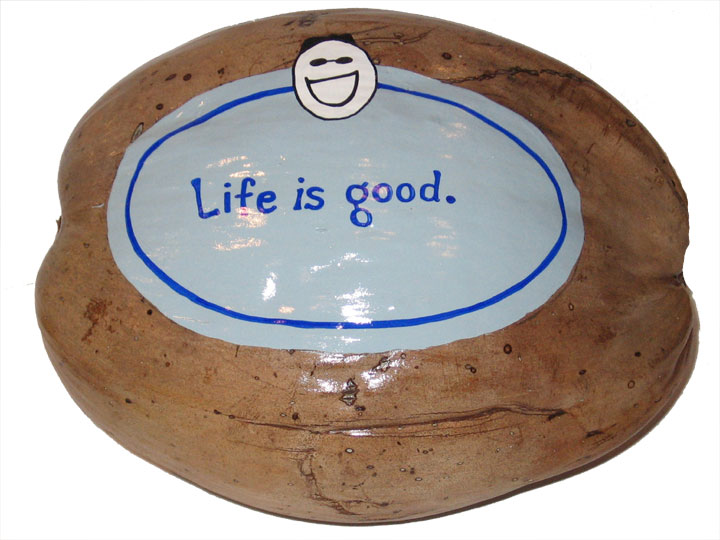 The Life is Good logo painted on a coconut for an unusual advertising specialty marketing promotion