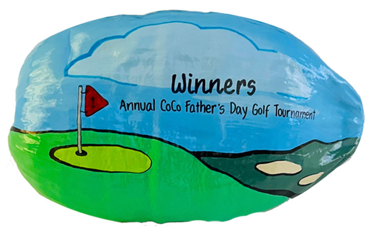 Painted coconut golf tournament trophy